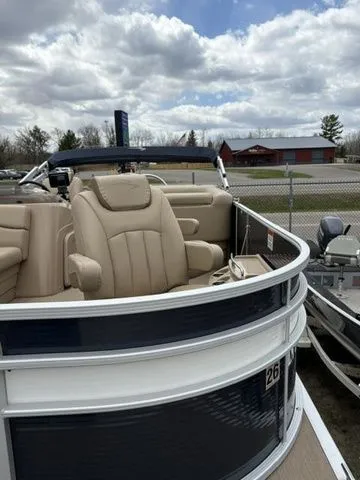 Slide: The Image of 2018 Bennington 21 SLX pontoon boat with beige seating outdoors. - 9