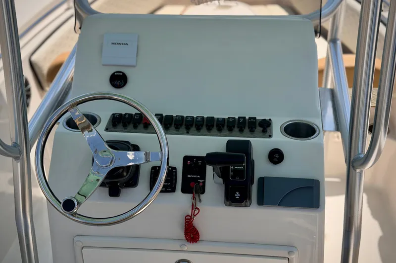 Slide: The Image of Steering console of 2026 Sea Chaser 22 HFC boat with controls and switches. - 10
