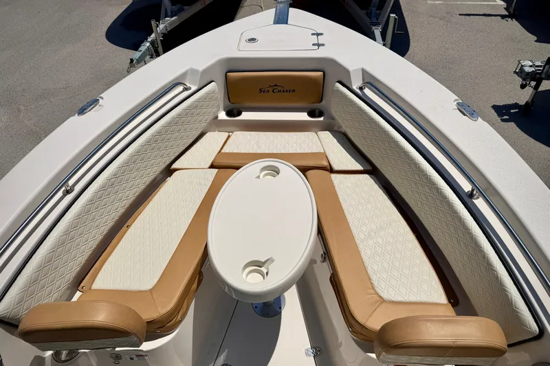 Slide: The Image of Interior view of 2026 Sea Chaser 22 HFC boat with cushioned seating and table. - 12
