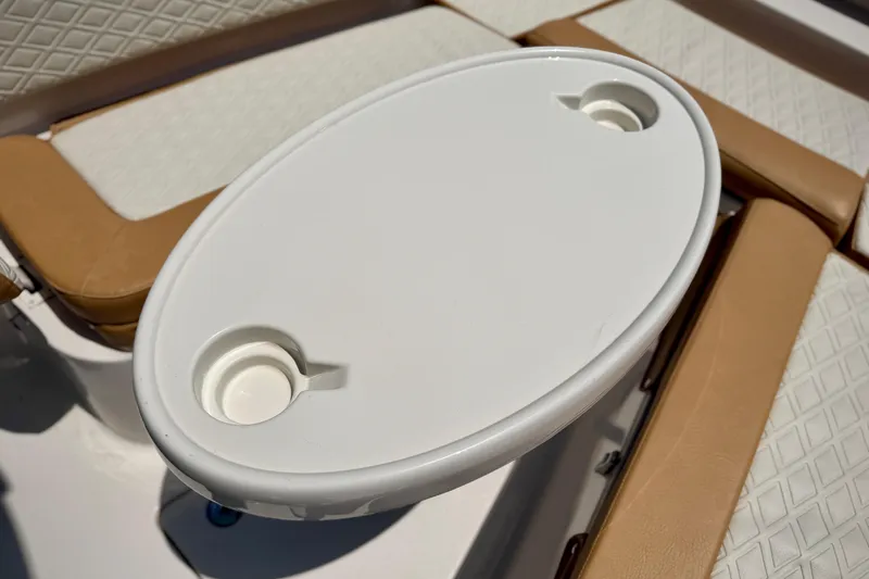 Slide: The Image of Oval table with cup holders on 2026 Sea Chaser 22 HFC boat. - 17