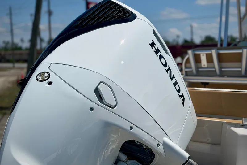 Slide: The Image of 2026 Sea Chaser 22 HFC with Honda outboard motor, close-up view. - 2