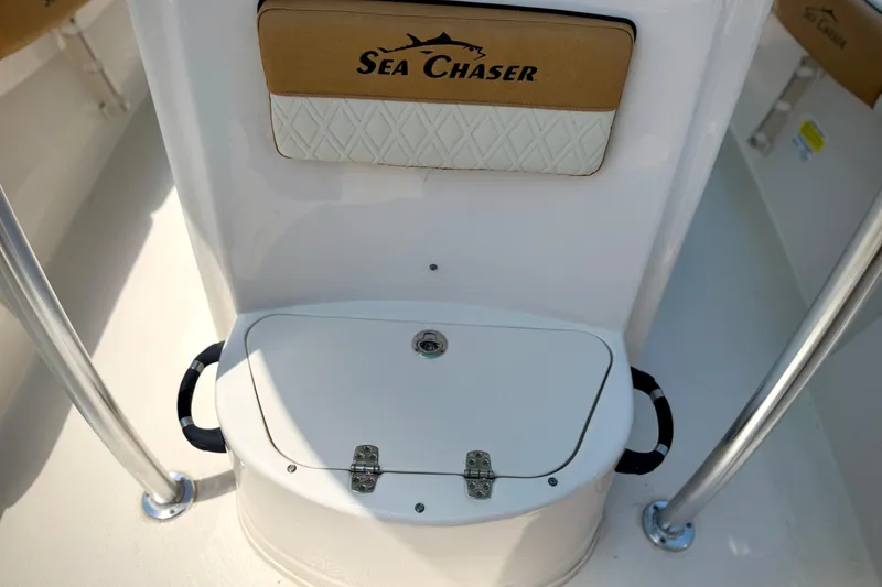 Slide: The Image of 2026 Sea Chaser 22 HFC boat interior with storage compartment and logo. - 22