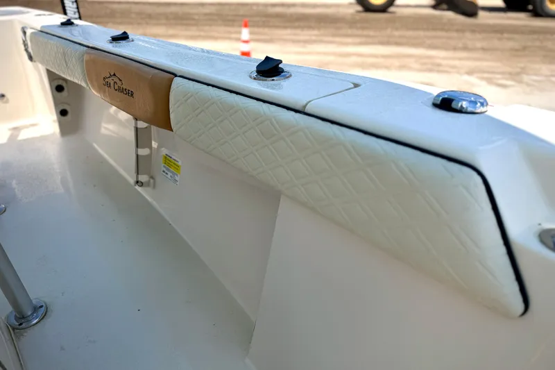Slide: The Image of 2026 Sea Chaser 22 HFC boat interior with padded seating and branded detail. - 25