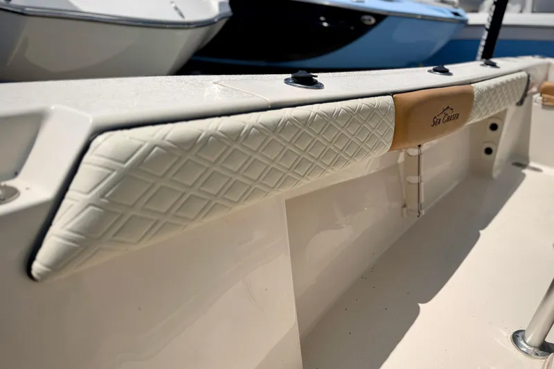 Slide: The Image of 2026 Sea Chaser 22 HFC boat interior with diamond-patterned upholstery detail. - 26