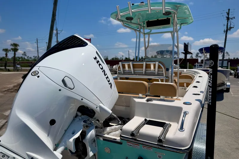 Slide: The Image of 2026 Sea Chaser 22 HFC boat with Honda outboard motor, docked under clear blue sky. - 3