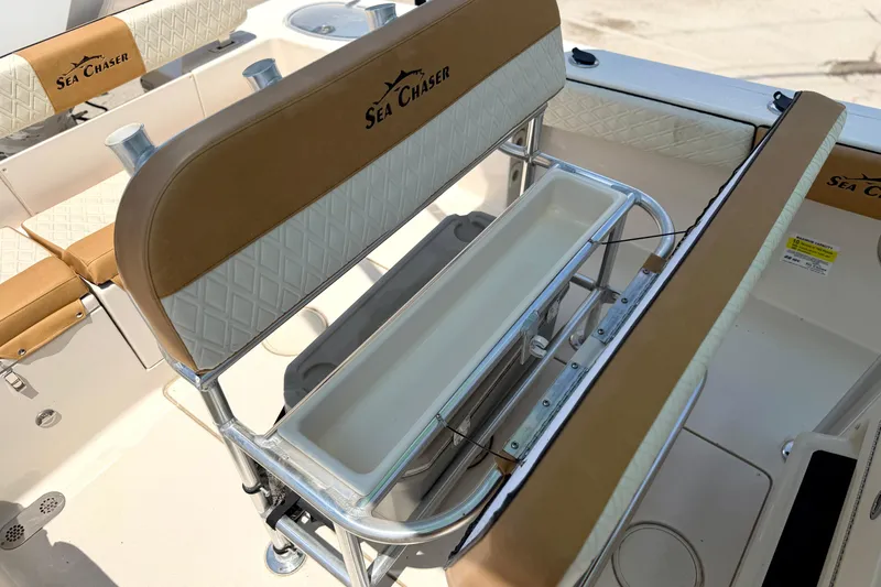 Slide: The Image of 2026 Sea Chaser 22 HFC boat interior with tan and white seating. - 31