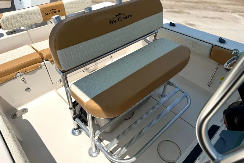Slide: The Image of 2026 Sea Chaser 22 HFC boat interior with tan and white seating. - 32
