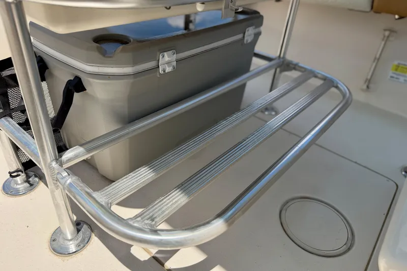 Slide: The Image of 2026 Sea Chaser 22 HFC boat with cooler storage rack and metal railings. - 33