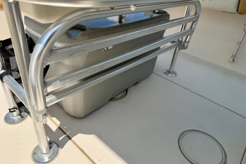 Slide: The Image of 2026 Sea Chaser 22 HFC boat interior with metal railing and storage compartment. - 34
