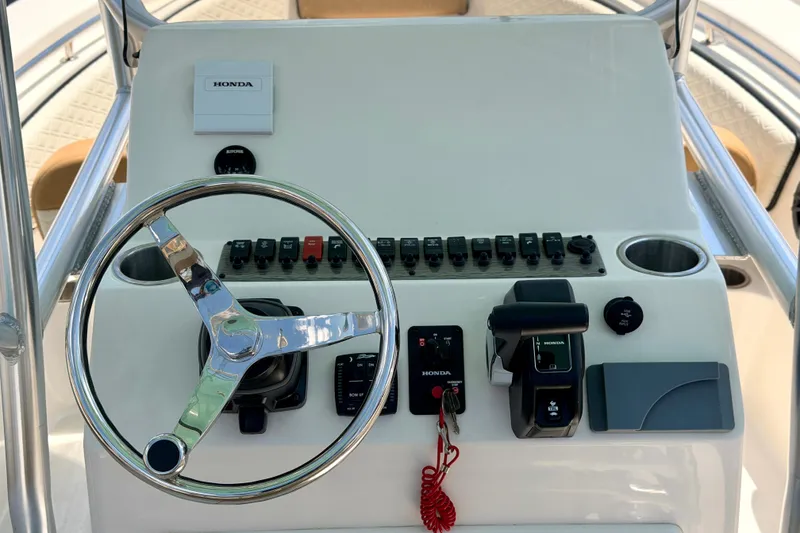 Slide: The Image of Steering console of 2026 Sea Chaser 22 HFC boat with Honda controls and switches. - 39