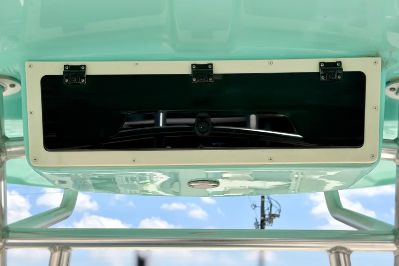Slide: The Image of 2026 Sea Chaser 22 HFC boat console with storage compartment, turquoise finish, and clear sky background. - 40