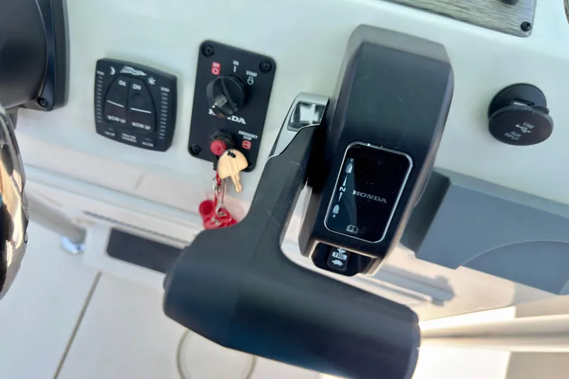 Slide: The Image of Control panel of 2026 Sea Chaser 22 HFC boat with Honda throttle and key ignition. - 43