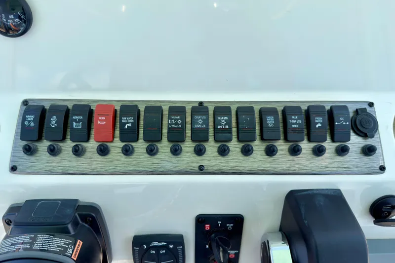 Slide: The Image of Control panel of 2026 Sea Chaser 22 HFC boat with labeled switches and dials. - 44