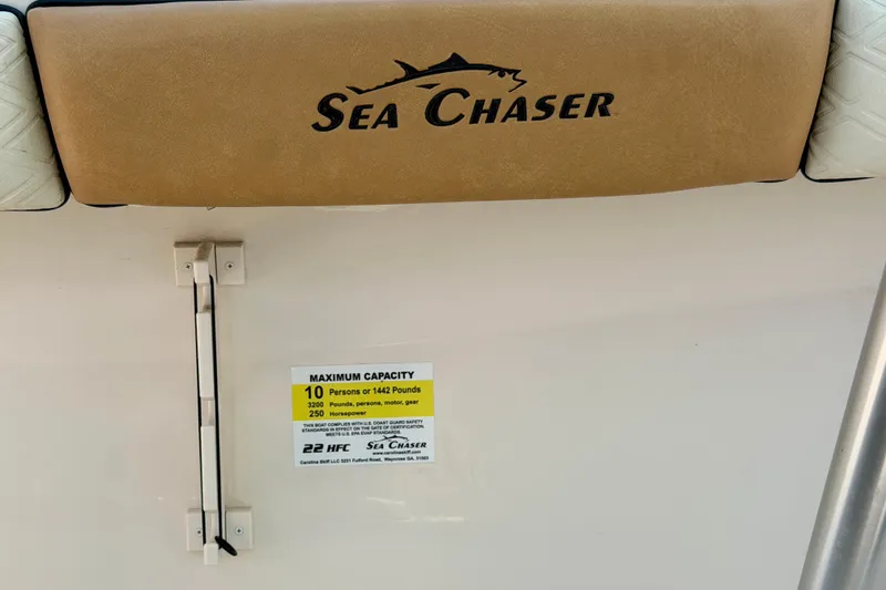 Slide: The Image of 2026 Sea Chaser 22 HFC boat capacity label, seating, and logo detail. - 48