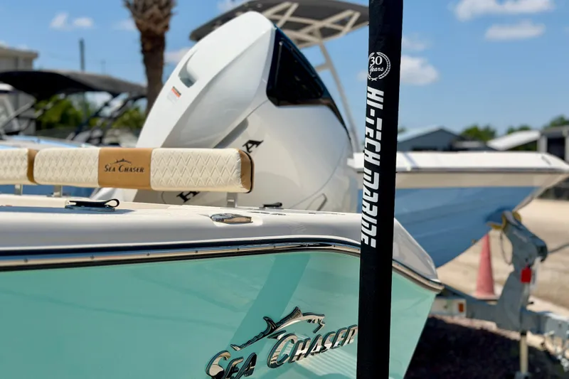 Slide: The Image of 2026 Sea Chaser 22 HFC boat, turquoise hull, Hi-Tech Marine branding, sunny day. - 5