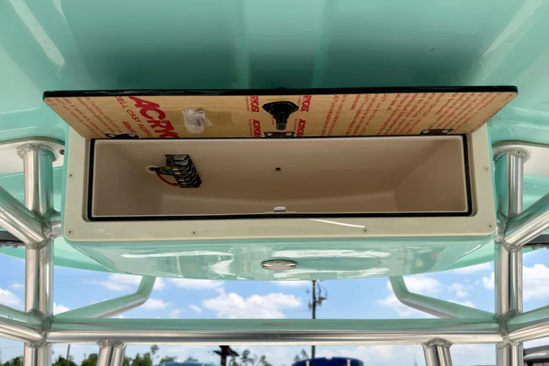 Slide: The Image of 2026 Sea Chaser 22 HFC boat storage compartment with wiring, open under blue sky. - 51