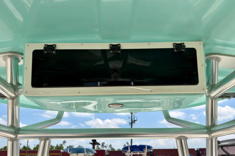 Slide: The Image of 2026 Sea Chaser 22 HFC boat storage compartment with stainless steel frame and turquoise finish. - 52