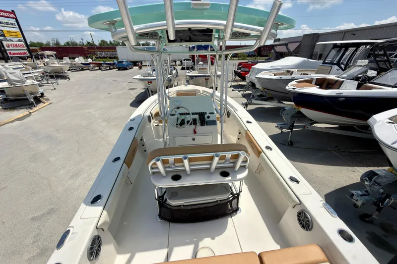 Slide: The Image of 2026 Sea Chaser 22 HFC boat interior view at a dealership, showcasing helm and seating. - 56
