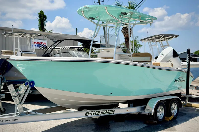 Slide: The Image of 2026 Sea Chaser 22 HFC boat on trailer, light blue hull, sunny day. - 58