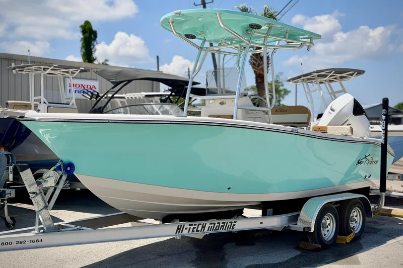 Slide: The Image of 2026 Sea Chaser 22 HFC boat on trailer, light blue hull, sunny day. - 59