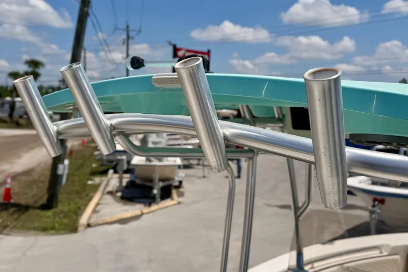 Slide: The Image of Rod holders on a 2026 Sea Chaser 22 HFC boat under a sunny sky. - 8