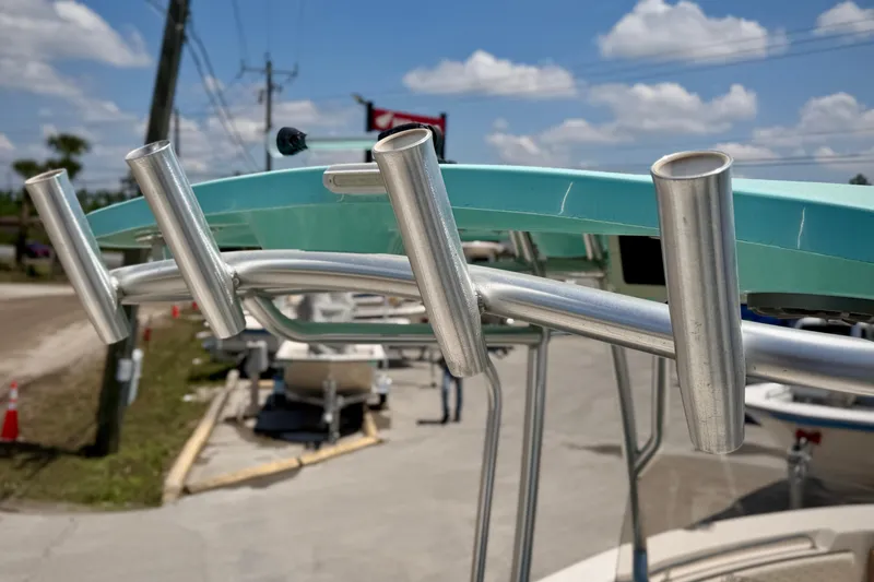 Slide: The Image of 2026 Sea Chaser 22 HFC boat with rod holders, under a clear blue sky. - 9