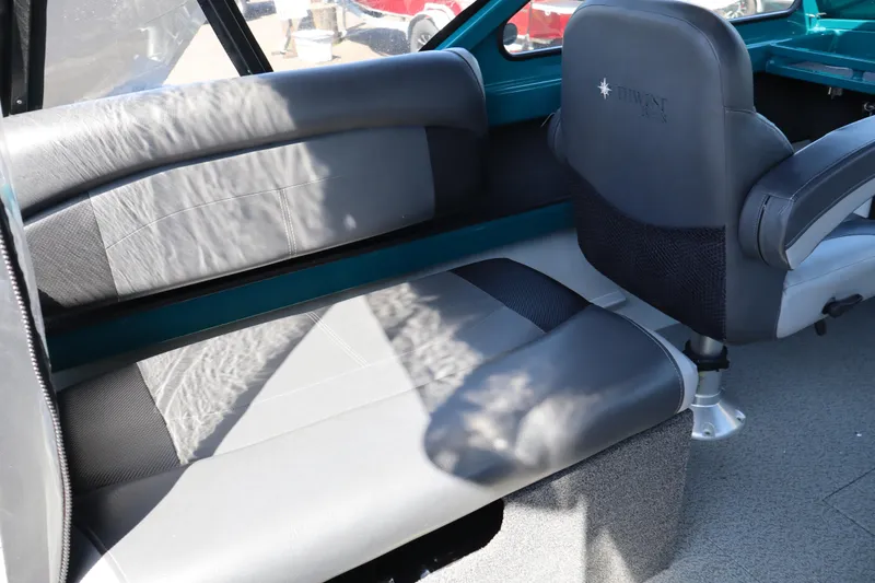 Slide: The Image of Interior seating of 2019 Northwest 208 SeaStar boat, featuring gray and black upholstery. - 11