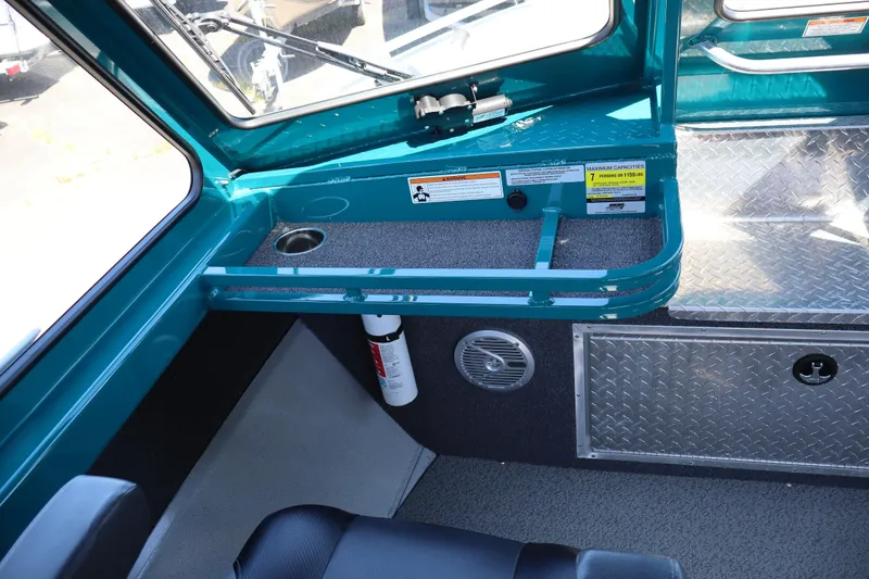 Slide: The Image of Interior of 2019 Northwest 208 SeaStar boat with teal accents and safety features. - 13