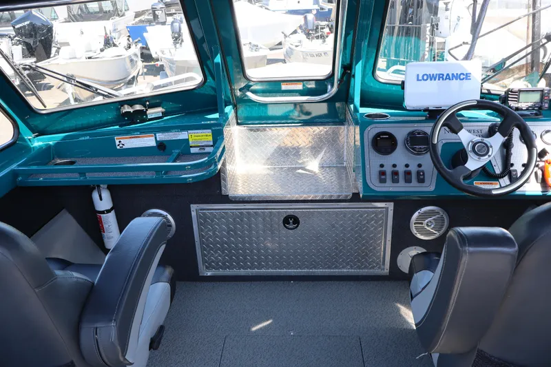 Slide: The Image of Interior of 2019 Northwest 208 SeaStar boat with steering wheel and navigation equipment. - 15