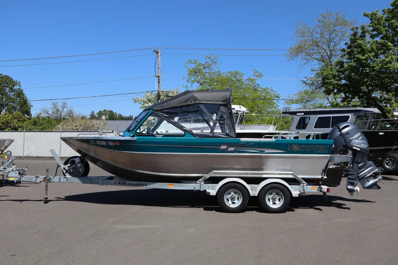 Slide: The Image of 2019 Northwest 208 SeaStar boat on trailer, parked outdoors under clear blue sky. - 19