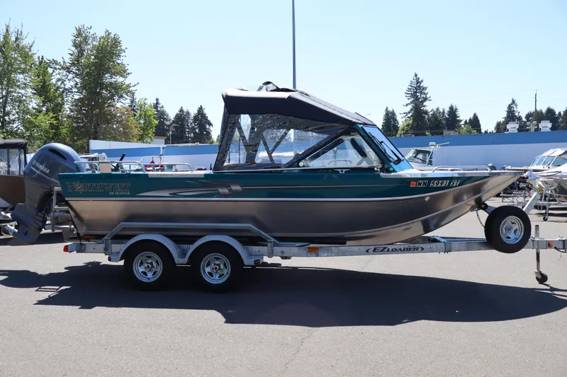 Slide: The Image of 2019 Northwest 208 SeaStar boat on trailer, parked outdoors in a sunny setting. - 21