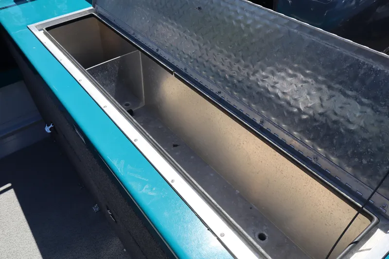 Slide: The Image of Open storage compartment on 2019 Northwest 208 SeaStar boat, featuring a teal and metal design. - 8
