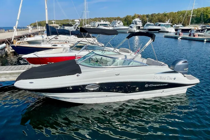 The Image of 2015 Crownline Eclipse E2 XS boat docked at a marina, surrounded by other vessels. - 0