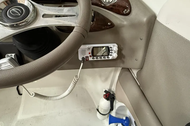 Slide: The Image of Steering wheel and control panel of 2015 Crownline Eclipse E2 XS boat. - 10