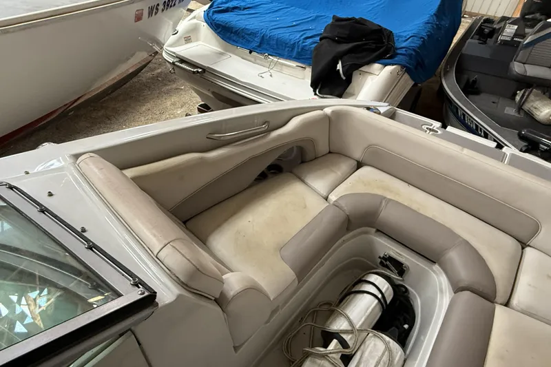 Slide: The Image of 2015 Crownline Eclipse E2 XS boat interior with beige seating in storage. - 11