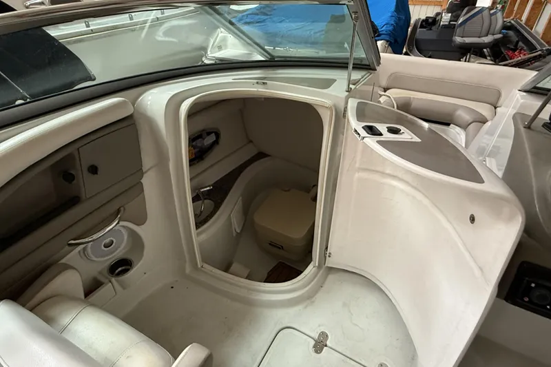 Slide: The Image of 2015 Crownline Eclipse E2 XS boat interior with open compartment and seating area. - 16