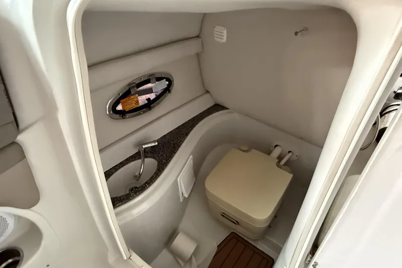 Slide: The Image of 2015 Crownline Eclipse E2 XS boat bathroom with sink and toilet. - 17