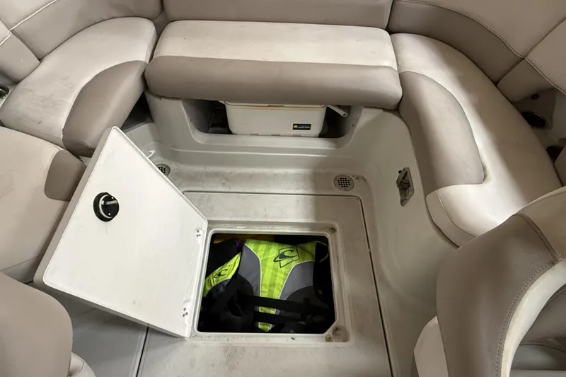 Slide: The Image of 2015 Crownline Eclipse E2 XS boat interior with open storage compartment and life jackets. - 19