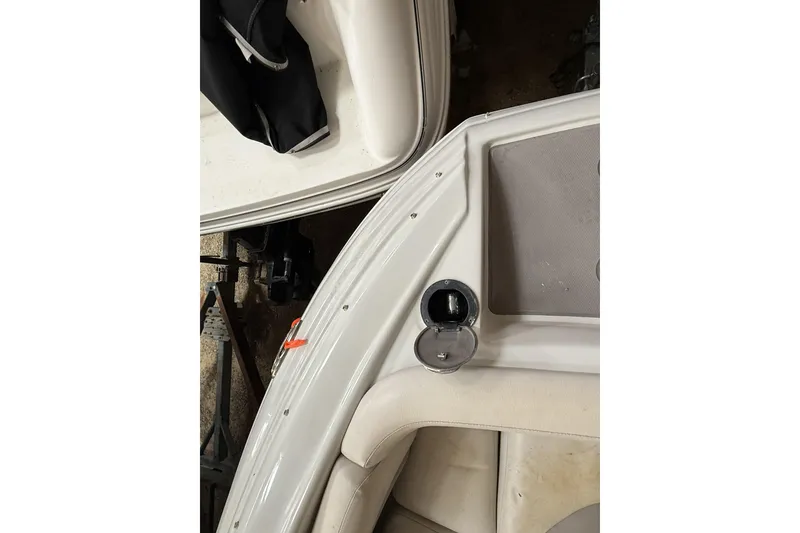 Slide: The Image of 2015 Crownline Eclipse E2 XS boat interior, featuring white seating and deck details. - 21