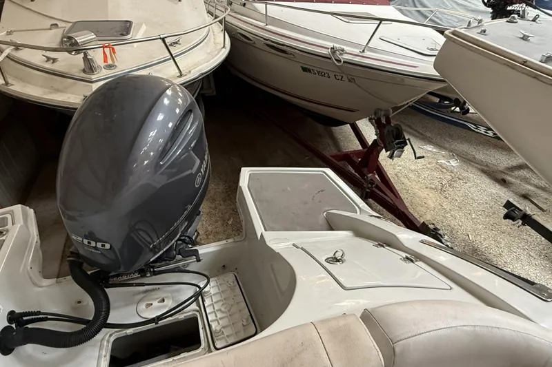 Slide: The Image of 2015 Crownline Eclipse E2 XS boat with Yamaha outboard motor in storage. - 23