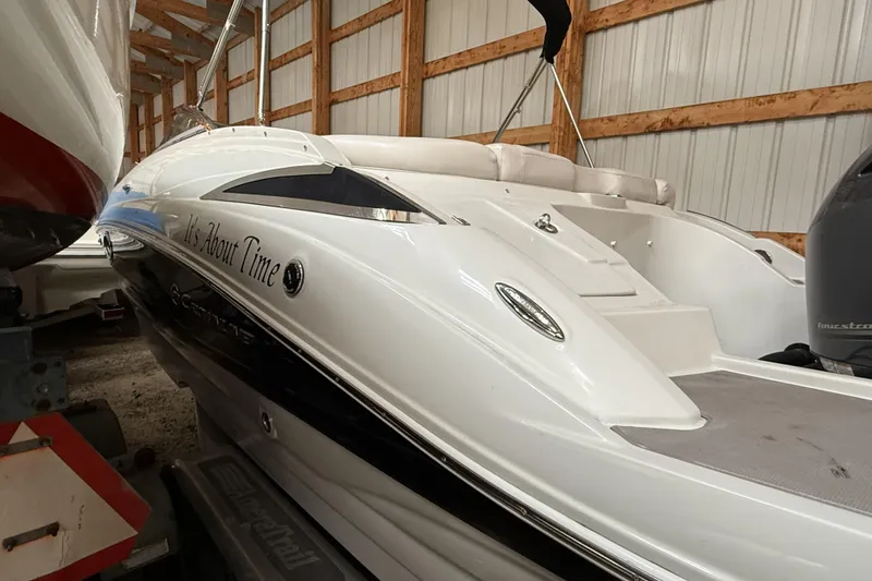 Slide: The Image of 2015 Crownline Eclipse E2 XS boat in storage, featuring sleek white and black design. - 26