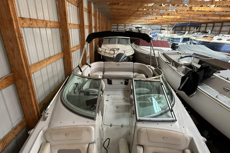 Slide: The Image of 2015 Crownline Eclipse E2 XS boat stored in a wooden boathouse. - 4