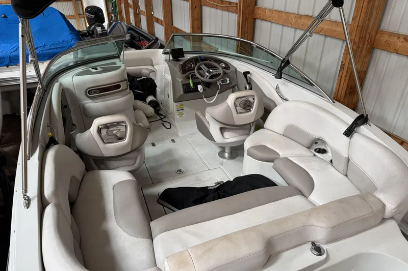 Slide: The Image of 2015 Crownline Eclipse E2 XS boat interior with white seating and steering console. - 5