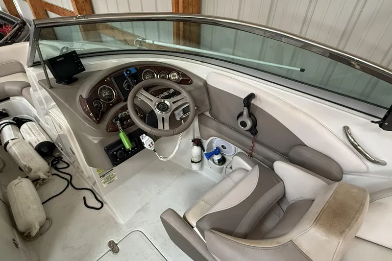 Slide: The Image of 2015 Crownline Eclipse E2 XS boat cockpit with steering wheel and control panel. - 6