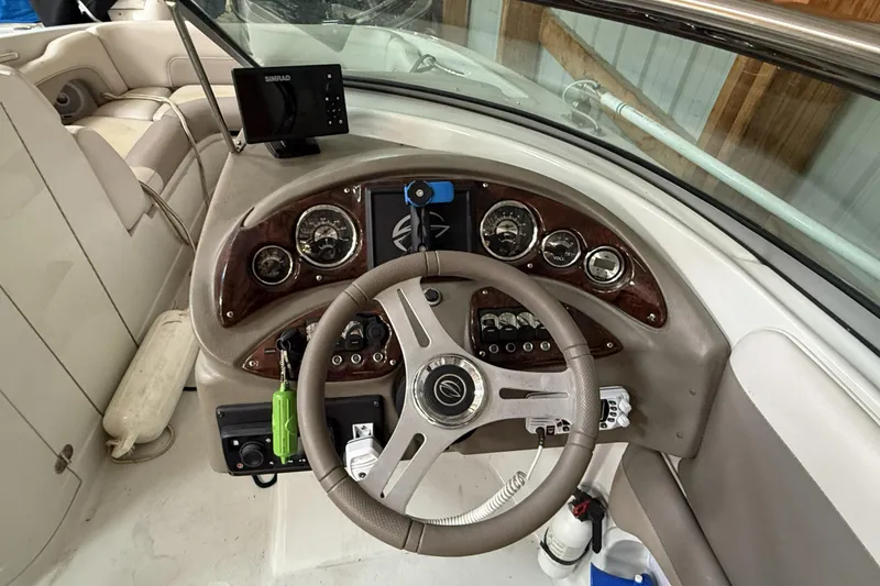 Slide: The Image of 2015 Crownline Eclipse E2 XS boat dashboard with steering wheel and navigation instruments. - 7