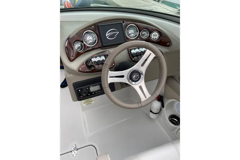 Slide: The Image of 2015 Crownline Eclipse E2 XS boat dashboard with steering wheel and control panel. - 8