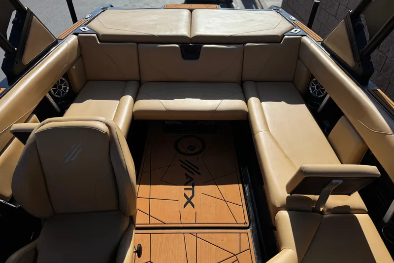 Slide: The Image of 2020 ATX 22 TYPE S boat interior with tan leather seating and branded flooring. - 17