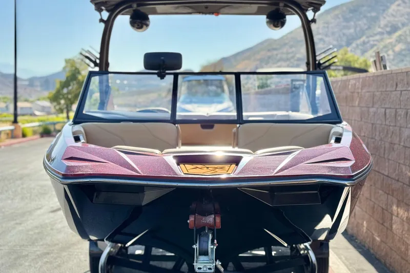 Slide: The Image of 2020 ATX 22 TYPE S boat with sleek design, parked outdoors. - 2