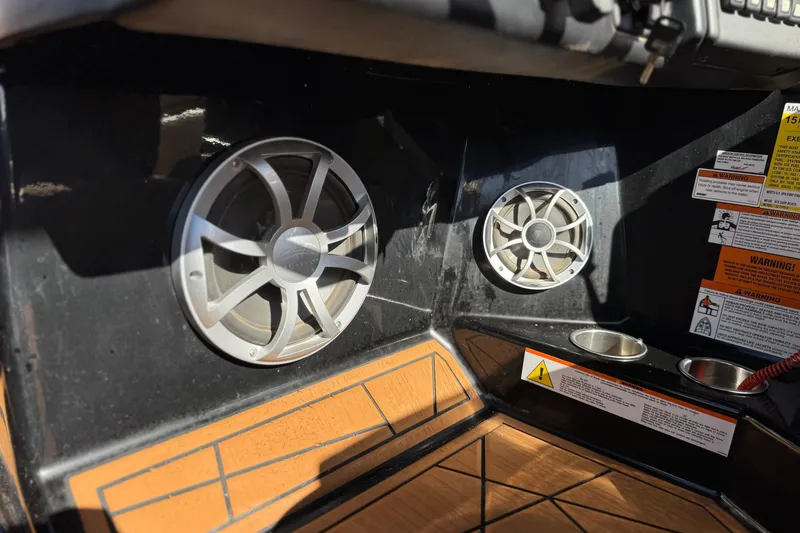 Slide: The Image of Interior of 2020 ATX 22 TYPE S boat with speakers and warning labels. - 33