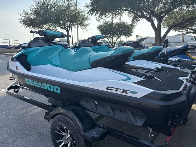 Slide: The Image of 2022 Sea-Doo GTX 130 PRO jet ski on trailer, blue and white design. - 3